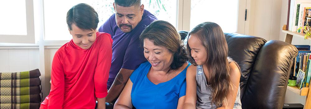 Grandparents are shown reading to their grandchildren in Hawaii