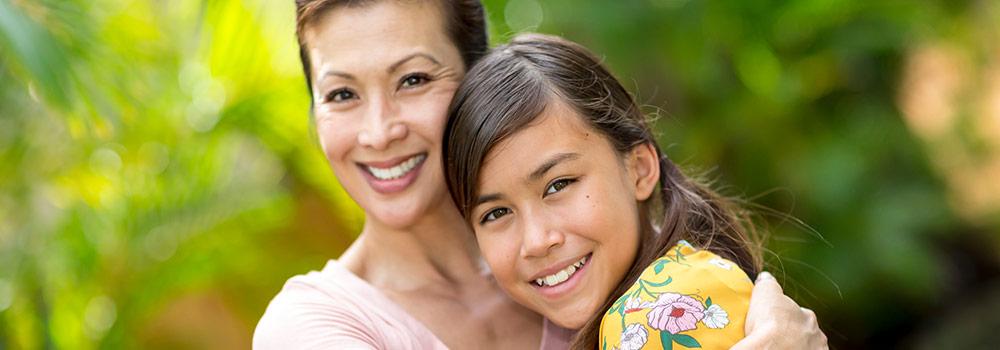 A Hawaiian mother and her daughter with beautiful teeth and healthy smiles. 